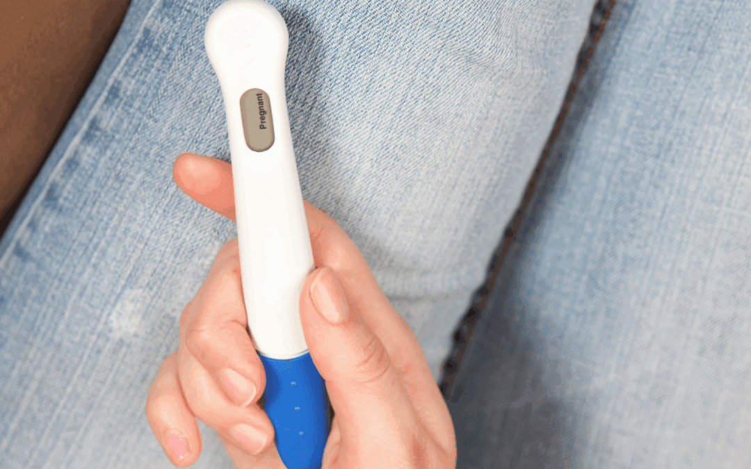 woman holding a positive pregnancy test