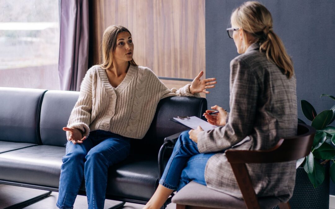 two women sitting together speaking